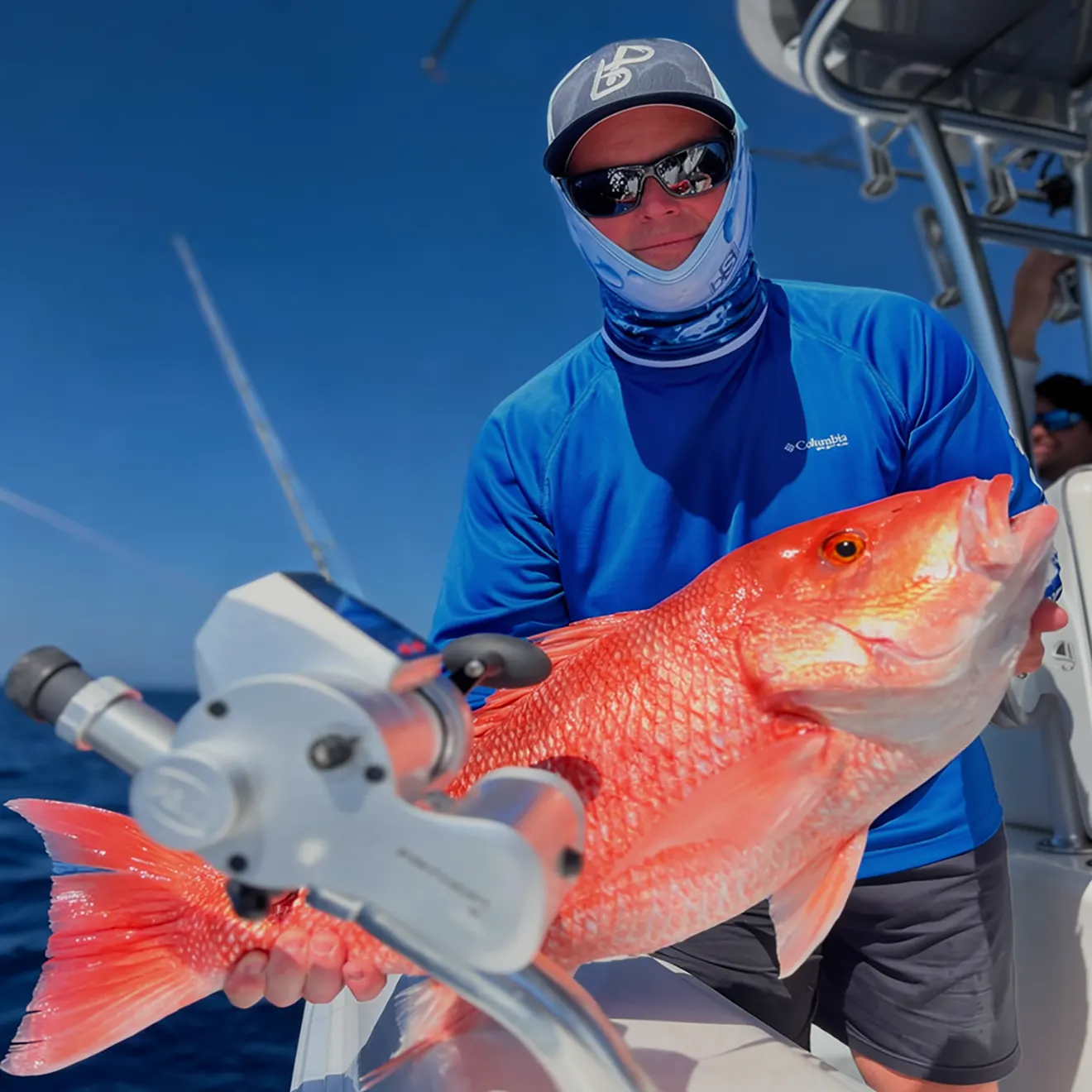 Angler holding a large red snapper during a Sarasota nearshore fishing charter.