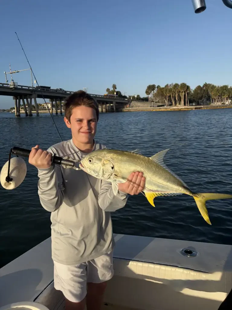 Boy holding a jack crevalle during a Sarasota fishing charter.