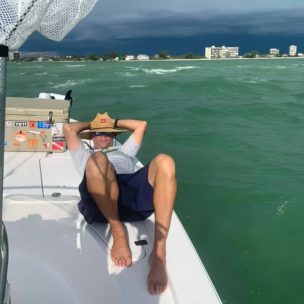 Guest relaxing on the bow of a private charter boat in Sarasota Bay before the next stop.