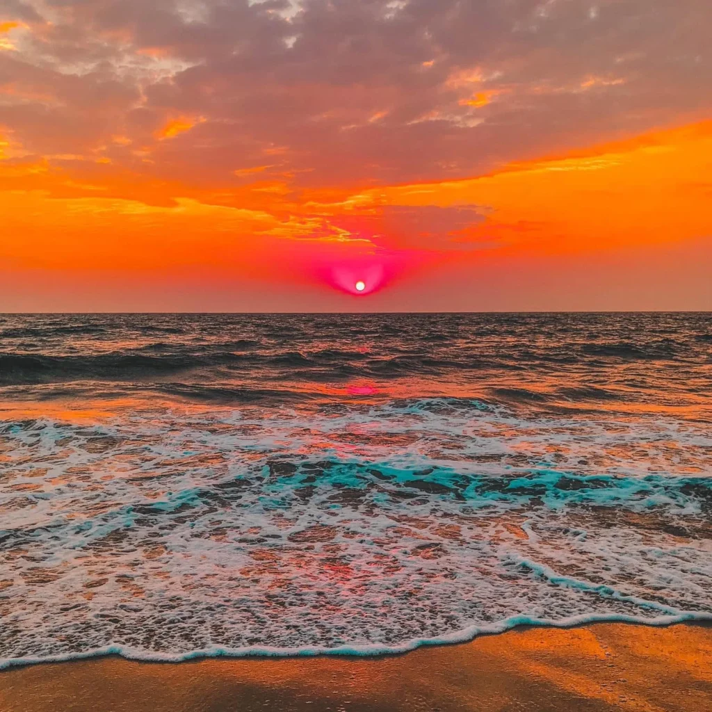 Colorful sunset over the Gulf of Mexico near Sarasota with waves washing onto the beach.
