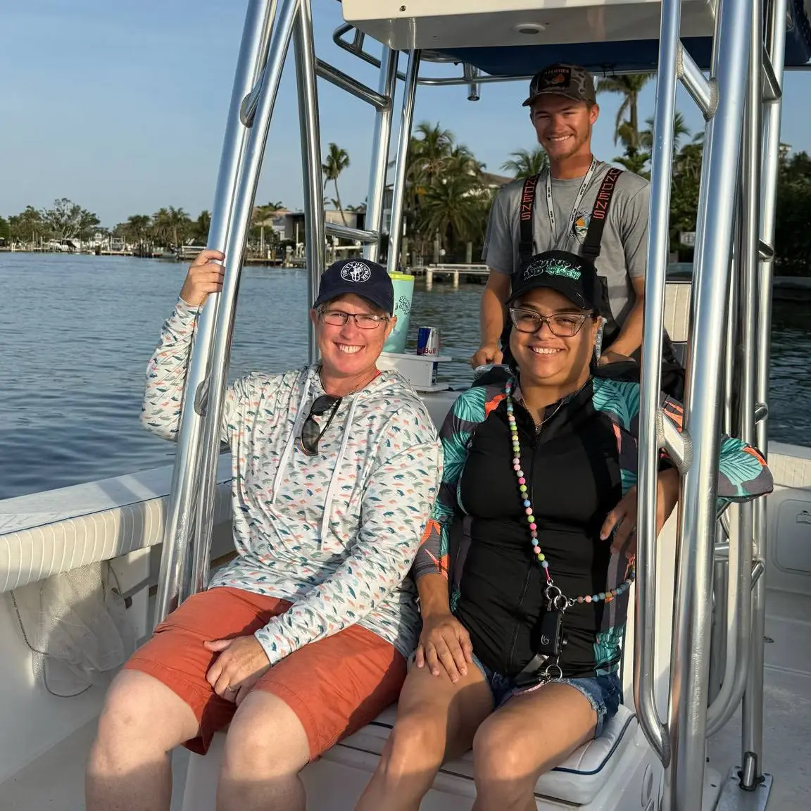 Happy guests with their captain aboard a Sarasota spring break fishing charter.