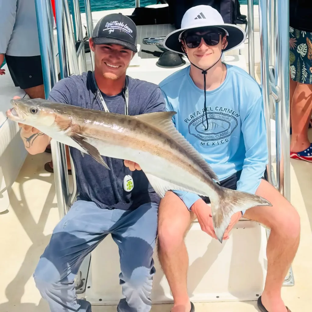 Teen angler holding a trophy cobia during a Sarasota spring break fishing charter.
