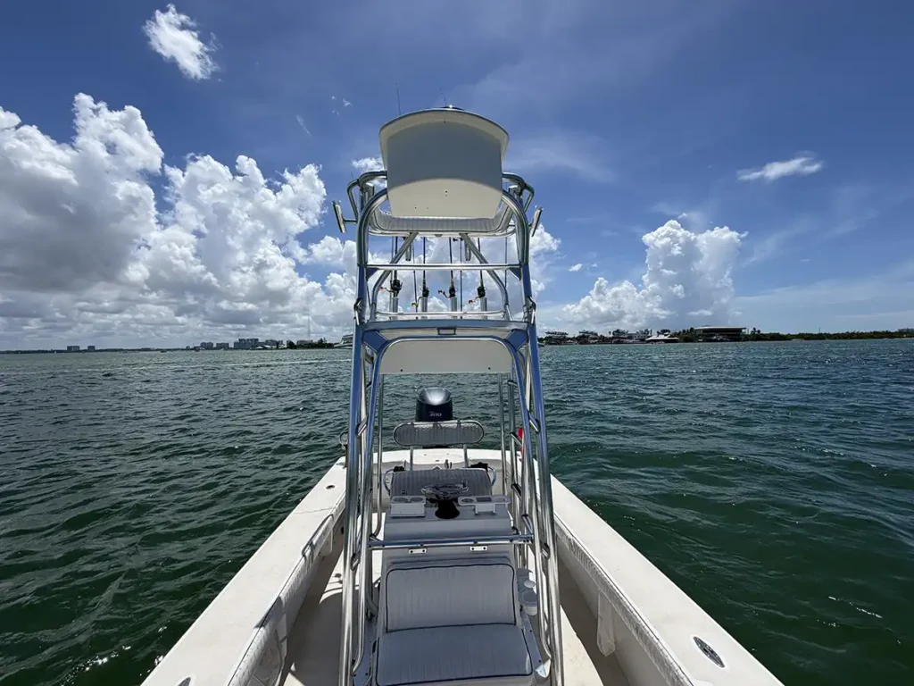 Fishing charter boat with tower and equipment in shallow water near Sarasota, Florida