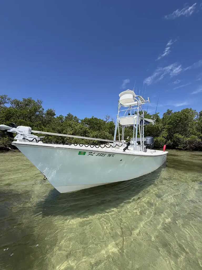 Bow view of a Sarasota fishing charter boat in clear shallow water near mangroves